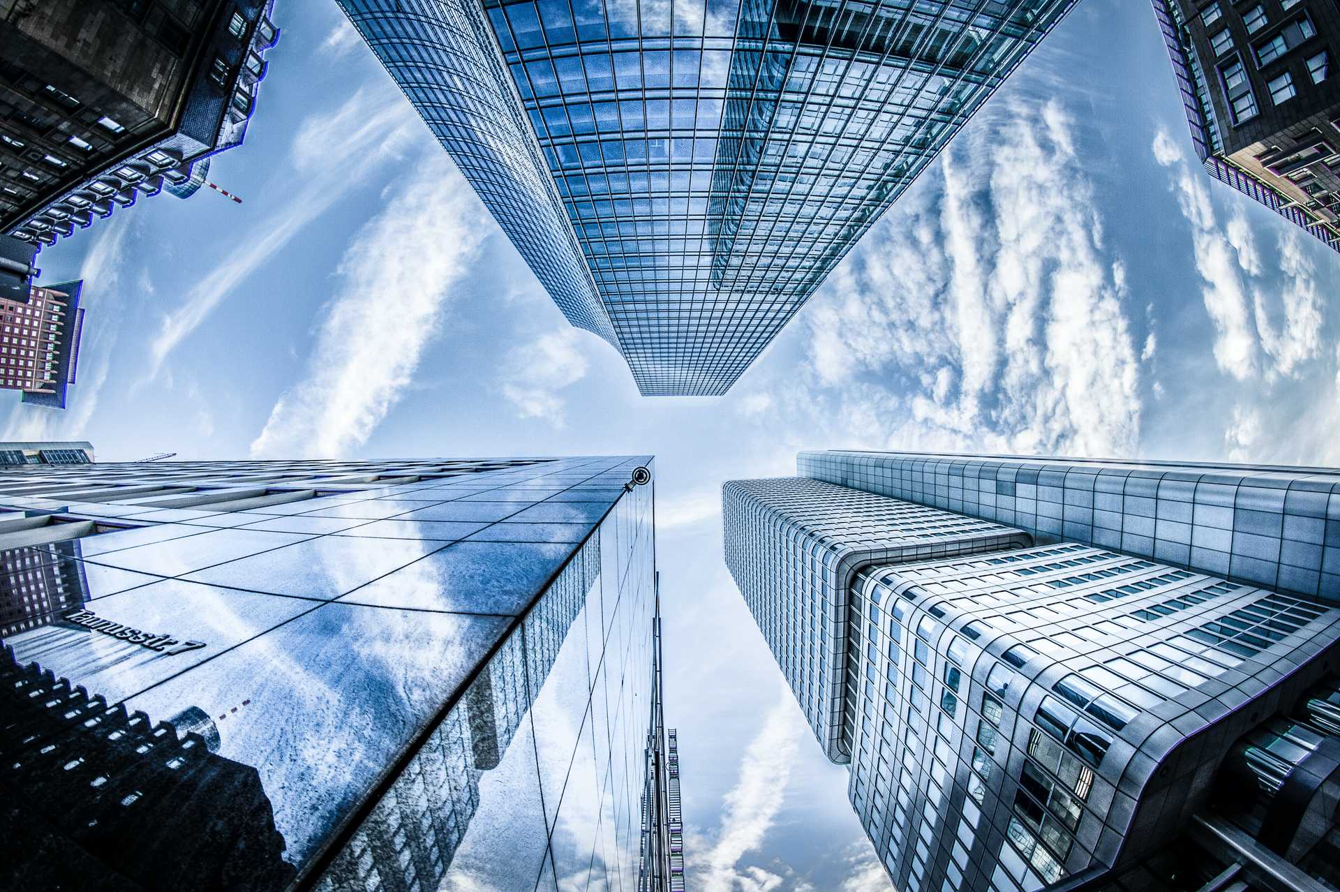 The view from below of several skyscrapers.